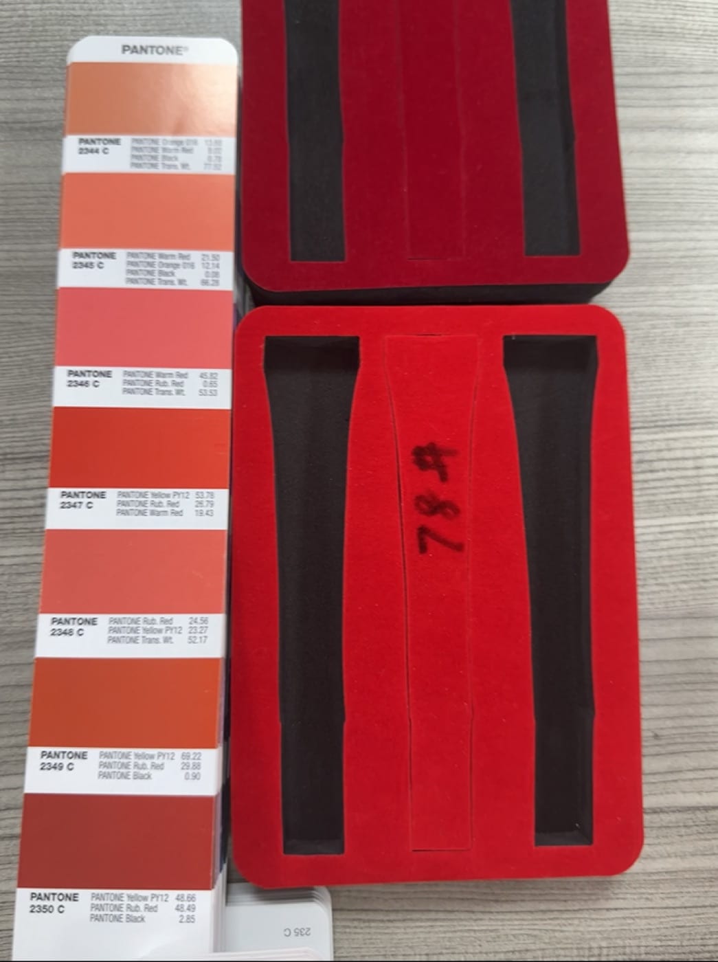 Printed tin sample checked against Pantone color references