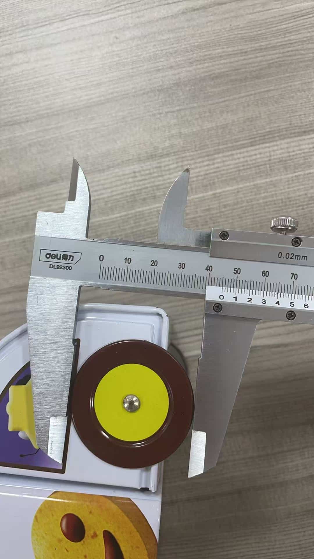 Real Junmei dimensional check using a vernier caliper on a tin component